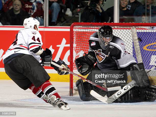 Todd Bertuzzi shoots the puck over the shoulder of goaltender Adam Jennings as he scores his only goal during the Brad May and Friends Hockey...