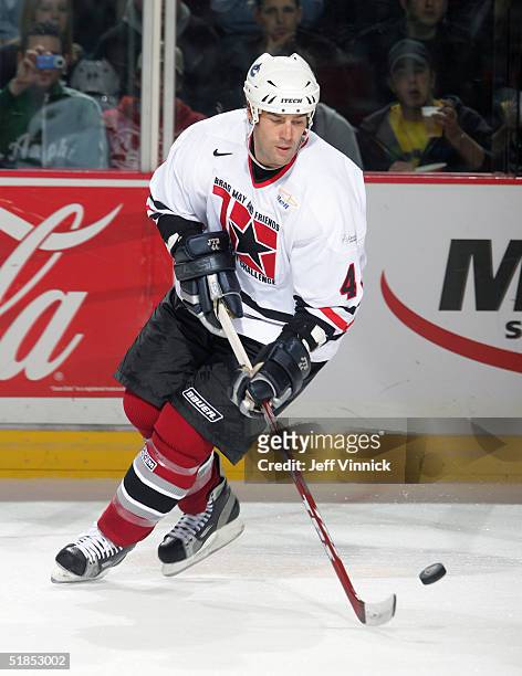 Todd Bertuzzi skates with the puck during the Brad May and Friends Hockey Challenge at the Pacific Coliseum on December 12, 2004 in Vancouver,...