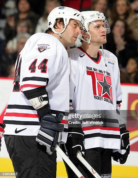 Todd Bertuzzi and Markus Naslund of the Vancouver Canucks talk as they stand on the ice during the Brad May and Friends Hockey Challenge at the...