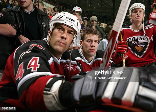 Todd Bertuzzi, Mattias Ohlund and Bryan Allen of the Vancouver Canucks sit on the bench during the Brad May and Friends Hockey Challenge at the...