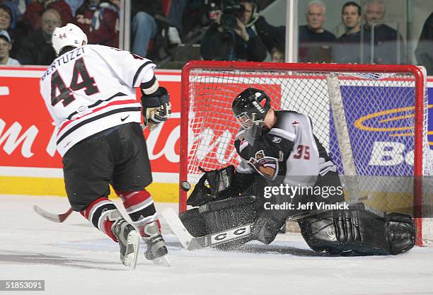 Todd Bertuzzi shoots the puck offf the goalpad of goaltender Adam Jennings during the Brad May and Friends Hockey Challenge at the Pacific Coliseum...