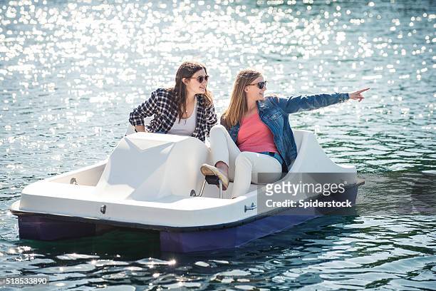 teenage girls on a paddle boat - pedal boat stock pictures, royalty-free photos & images