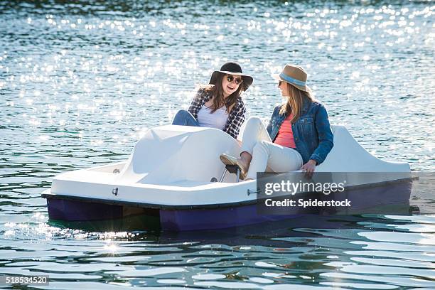 teenage girls on a paddle boat - paddleboat stock pictures, royalty-free photos & images