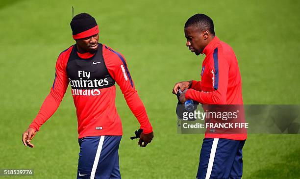 Paris Saint-Germain's French defender Serge Aurier and Paris Saint-Germain's French midfielder Blaise Matuidi arrive for a training session on April...