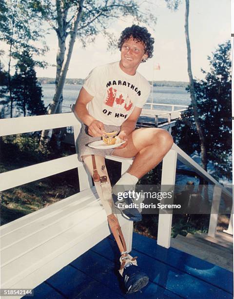 Terry Fox takes a break from the gruelling pace in July during his run through Ontario.