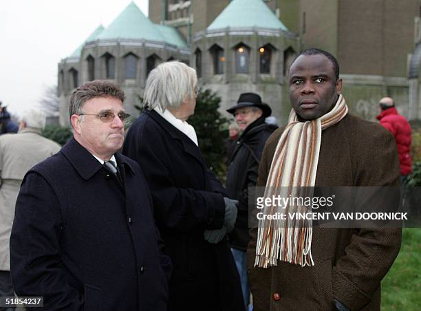 Former Belgian football player Georges Heylens and former French player Basile Boli arrive at the Koekelberg Basilica in Brussels for the funeral of...