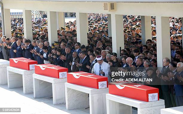 Mourners attend the funeral ceremonies of Turkish police officers Necdet Alici, Mustafa Yigitalp, Mehmet Fatih Ertugrul and Alper Zor, who were among...