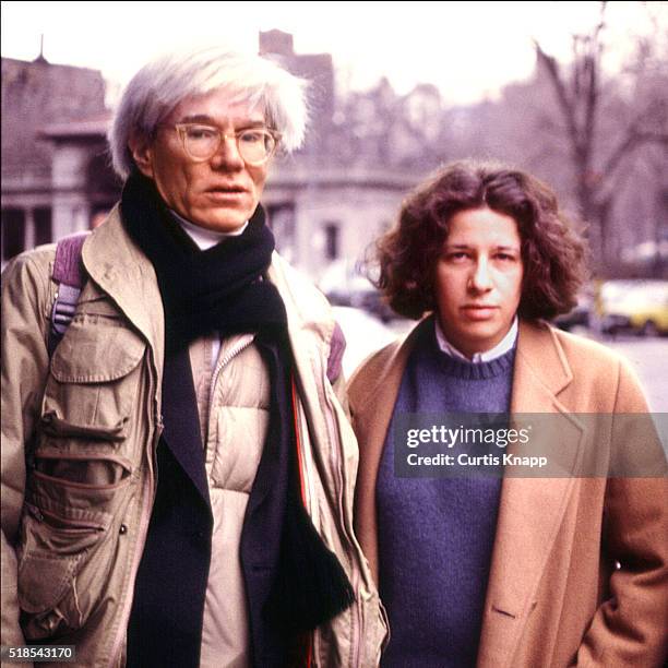 Portrait of American Pop artist Andy Warhol and author Fran Lebowitz as they stand together on a street, New York, New York, January 14, 1983.