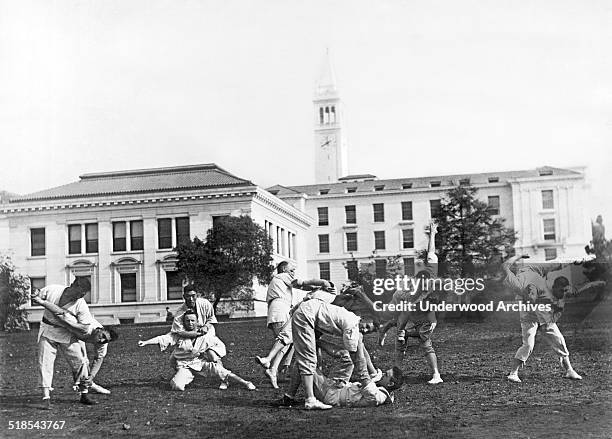 Martial arts class practices on the University of California campus with the Campanile rising in the background, Berkeley, California, late 1890s or...