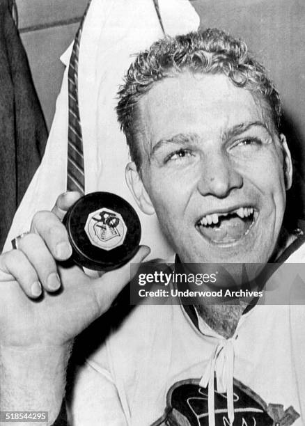 Chicago Black Hawks star Bobby Hull holds up the puck with which he scored his 50th goal of the season, becoming the third man in the history of the...