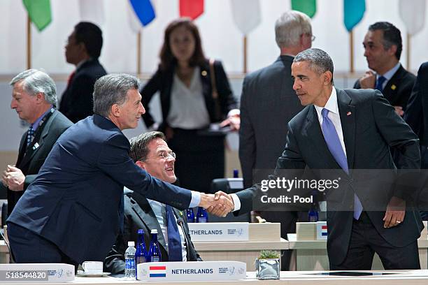 President Barack Obama, right, shakes hands with Mauricio Macri, Argentina's president, during an opening plenary entitled 'National Actions to...