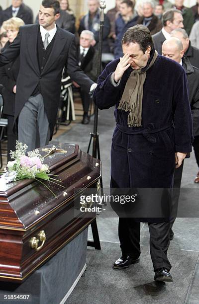 Former director of the Olymique de Marseille , Jean-Pierre Bernes greets the coffin during the funeral service of late soccer coach Raymond Goethals...