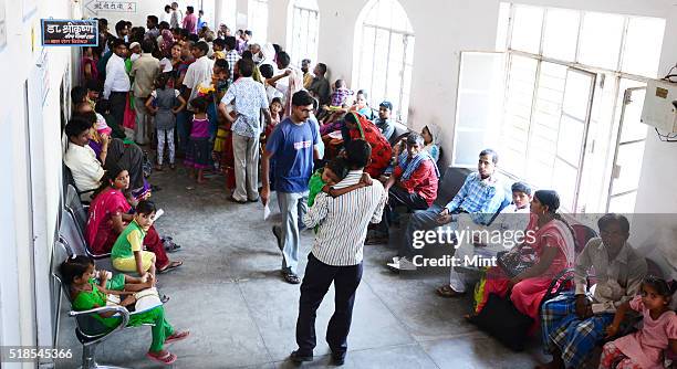 Patients queued up at OPD at a Bareilly district hospital to show their children suffering from Non Polio Acute Flaccid Paralysis on July 3, 2015 in...