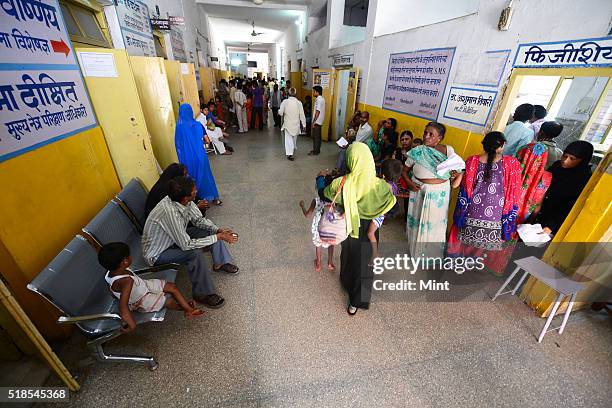 Patients queued up at OPD at a Bareilly district hospital to show their children suffering from Non Polio Acute Flaccid Paralysis on July 3, 2015 in...