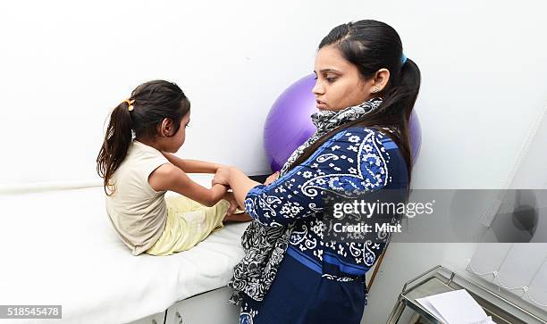 Six years old Anshika, who has tested positive for AFP, is undergoing her physiotherapy session at a local clinic on July 3, 2015 in Bareilly, India....