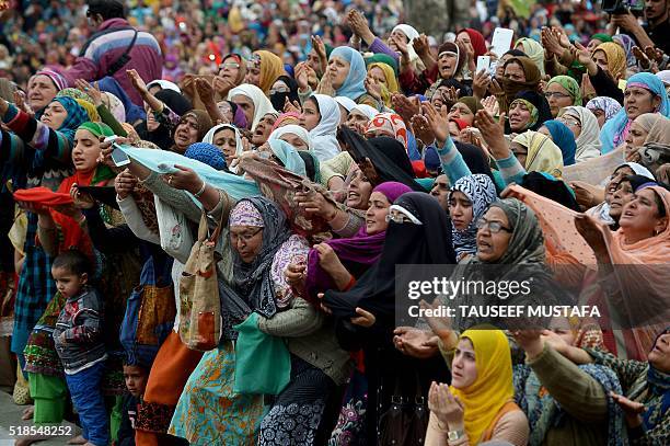 Kashmiri Muslims react as a cleric shows a relic believed to be a hair from the beard of the Prophet Mohammed during special prayers on the death...