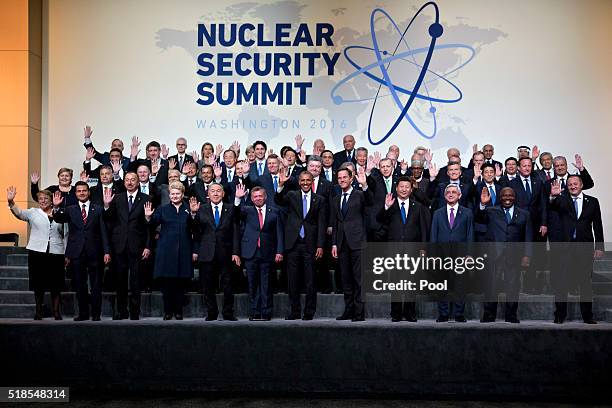 President Barack Obama waves among other heads of state and attendees during a family photo at the Nuclear Security Summit on April 1, 2016 in...