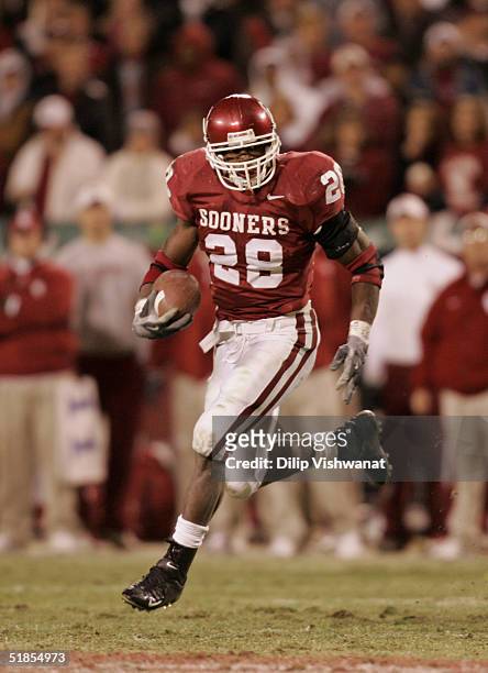 Adrian Peterson of the University of Oklahoma Sooners carries the ball against the University of Colorado Buffaloes in the Big 12 Championship game...