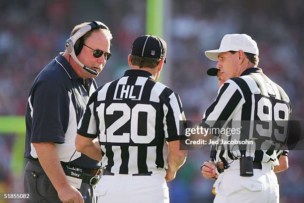 Head coach Mike Holmgren of the Seattle Seahawks speaks with officials John McGrath and Tony Corrente of the San Francisco 49ers at Monster Park on...