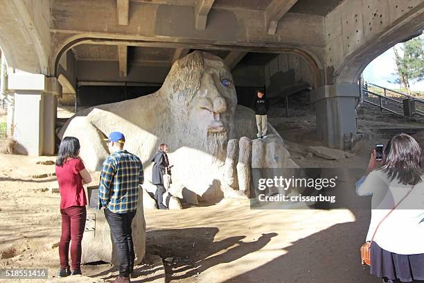 tourists at the fremont troll - seattle, washington - seattle troll stock pictures, royalty-free photos & images