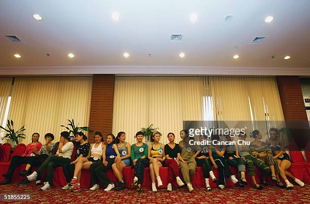 Contestants wait for a training session during China's first ever Miss Plastic Surgery contest on December 13, 2004 in Beijing, China. 19 contestants...