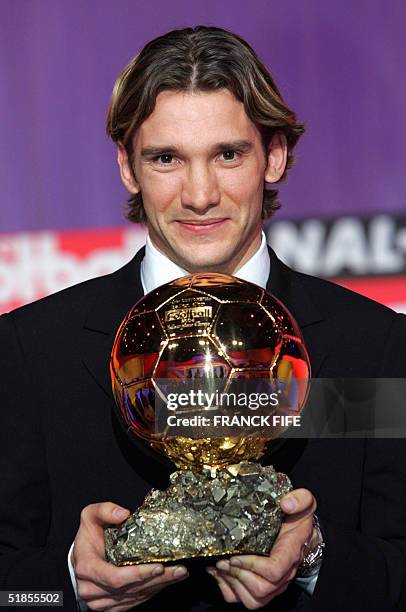 Milan's Ukrainian striker Andriy Shevchenko poses with his trophy, the golden goal, 13 December 2004 in Paris, after being awarded European...