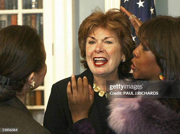 Assistant Secretary of State for Eductational and Cultural Affairs Patricia Harrison receives a last second unscheduled touch-up on her hair from...