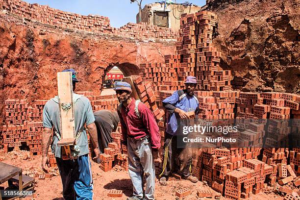 Brick factory workers transporting ready-to brick red brick truck-mounted outside the plant after completion of the processing of the bricks...