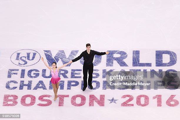 Sumire Suto and Francis Boudreau Audet of Japan celebrate after completing their routine in the Pairs Short Program during Day 5 of the ISU World...