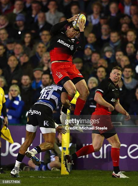 Alex Goode of Saracens is tackled in the air by Anthony Watson of Bath resulting in a red card during the Aviva Premiership match between Bath Rugby...