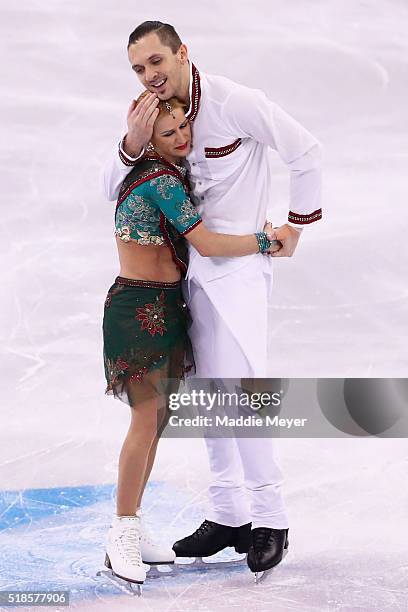 Tatiana Volosozhar and Maxim Trankov of Russia celebrate after completing their routine in the Pairs Short Program during Day 5 of the ISU World...