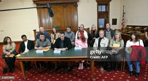 Members of the Scott Peterson jury sit together as they read a statement during a news conference December 13, 2004 in Redwood City, California. Seen...