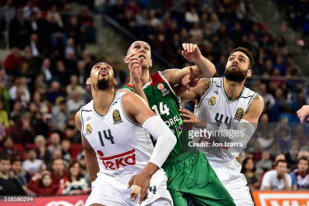Kim Tillie, #14 of Laboral Kutxa Vitoria Gasteiz competes with Gustavo Ayon, #14 of Real Madrid and Jeffery Taylor, #44 of Real Madrid during the...