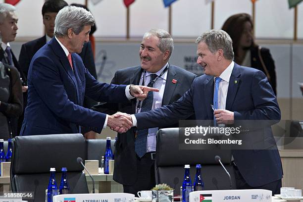 John Kerry, U.S. Secretary of State, left, talks to Sauli Niinisto, Finland's president, right, and Nasser Judeh, Jordan's minister of foreign...