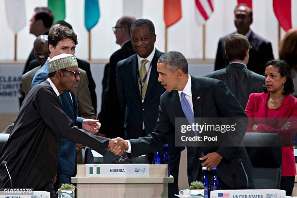 President Barack Obama shakes hands with Muhammadu Buhari, Nigeria's president, during a closing session at the Nuclear Security Summit April 1, 2016...