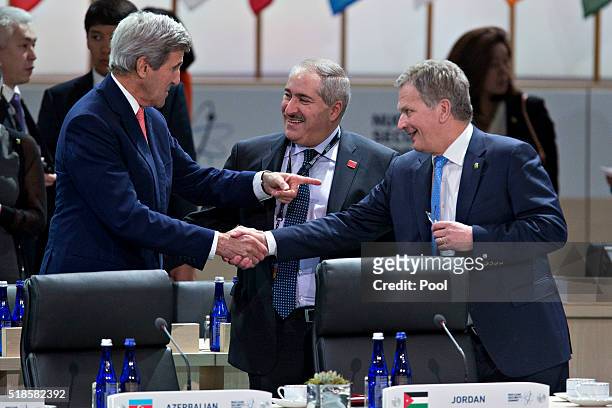 John Kerry, U.S. Secretary of State talks to Sauli Niinisto, Finland's president and Nasser Judeh, Jordan's minister of foreign affairs during a...