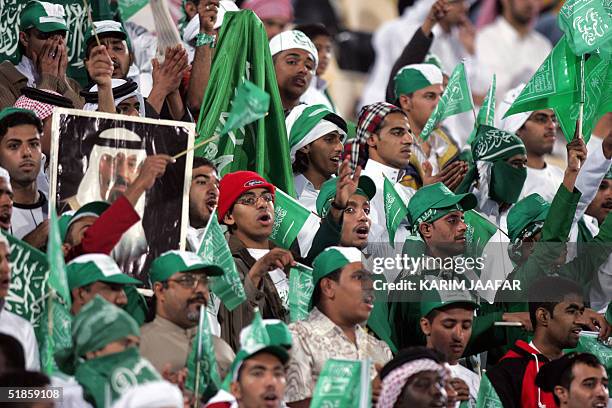 Fans of the Saudi team cheer their players during the Yemen-Saudi Arabia 17th Arabian Gulf Cup match in Doha 14 December 2004. The Saudis won 2-0....