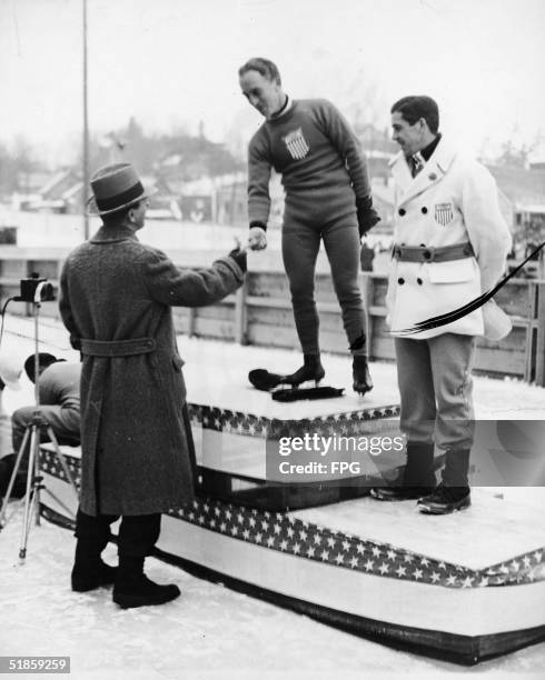 American skater Irving Jaffee shakes hands with an unidentified Olympic official after winning the gold medal in the Men's 5,000-Metre Speed Skating...