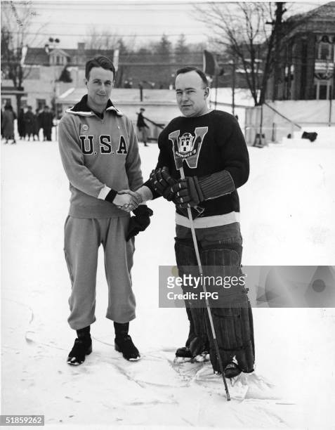 The captains of the American and Canadian Olympic ice hockey teams, John Chase of the USA and William Cockburn of Canada, shake hands as their teams...