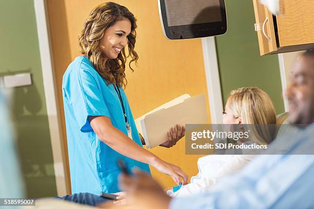 nurse receiving information from patient before she donates blood - receiving blood stock pictures, royalty-free photos & images