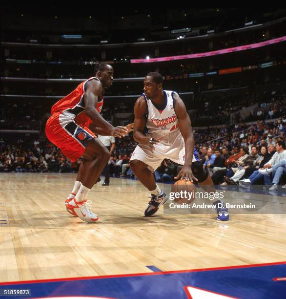 Elton Brand of the Los Angeles Clippers drives against Emeka Okafor of the Charlotte Bobcats during a game at Staples Center on December 6, 2004 in...