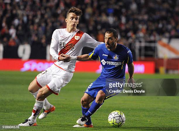 Mehdi Lacen of Getafe is challenged by Diego Llorente of Rayo Vallecano de Madrid during the La Liga match between Rayo Vallecano and Getafe CF at...