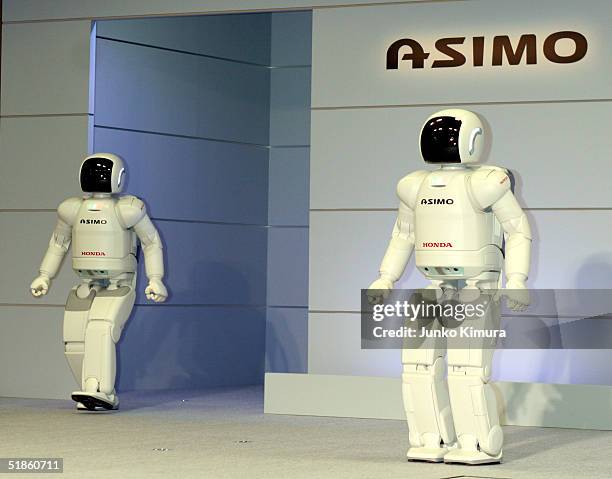 Honda Motor Co.'s humanoid robots, Asimo, appear during a press review December 15, 2004 in Tokyo, Japan. Honda announced the development of new...
