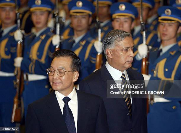 Visiting Pakistan Prime Minister Shaukat Aziz walks with Chinese Premier Wen Jiabao during a review of the honour guard welcoming ceremony at the...
