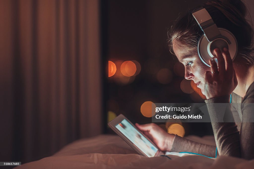 Woman using tablet pc in evening.