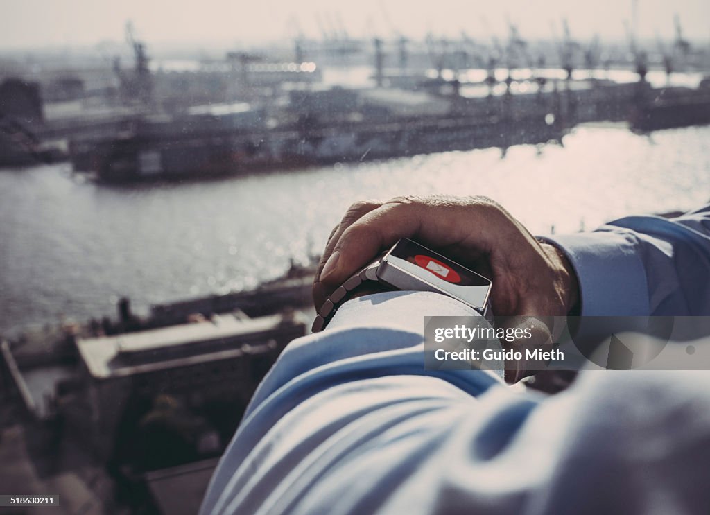 Business man using smartwatch.