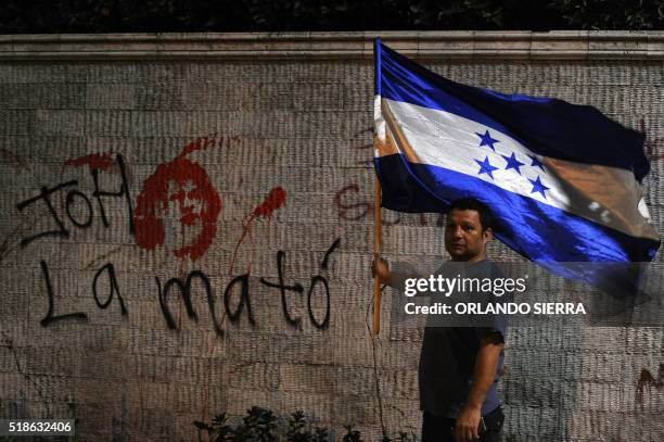 Demonstrator takes part in a protest to claim justice after the murdered of indigenous activist leader Berta Caceres outside the Central American...