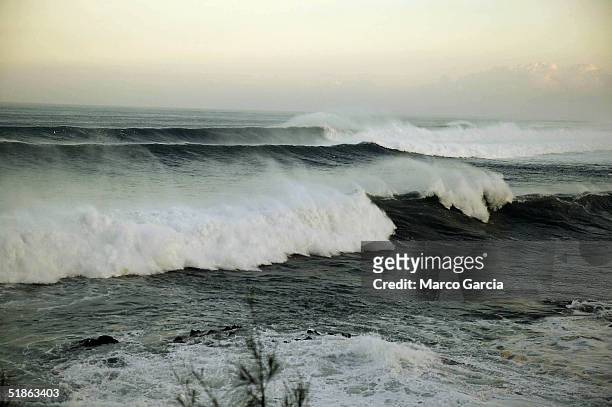 Large waves crash at Waimea Bay at dawn December 15, 2004 in Oahu, Hawaii. Weather forecasts predicted 30-50 foot waves to crash into Oahu's North...