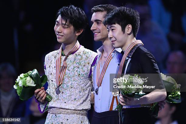 The podium is filled with from left, silver medalist Yuzuru Hanyu of Japan, gold medalist Javier Fernandez of Spain, and bronze medalist Boyang Jin...