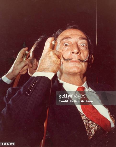 Portrait of Spanish artist Salvador Dali with his cane, 1960s.